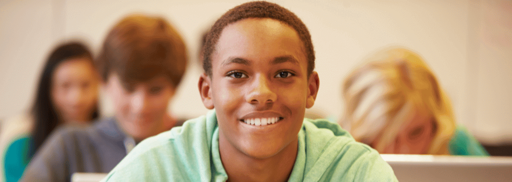 Recipient of scholarships for high school seniors smiles in school classroom
