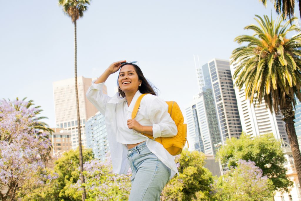 Smiling student writes her SCU supplemental